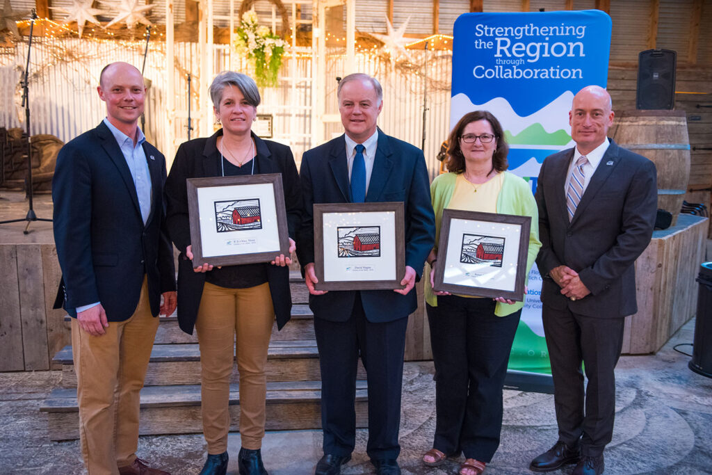 Award winners pose next to NRVRC sign