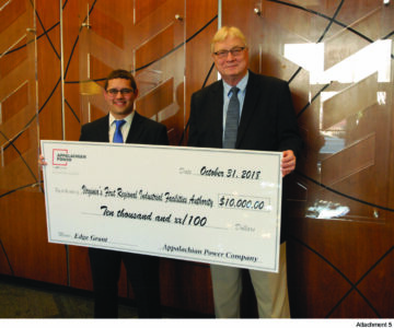 Two men pose with giant check