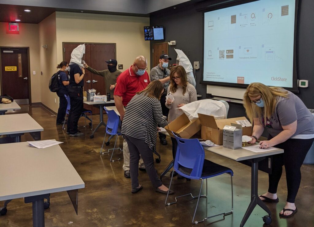 Group of people with face masks and boxes