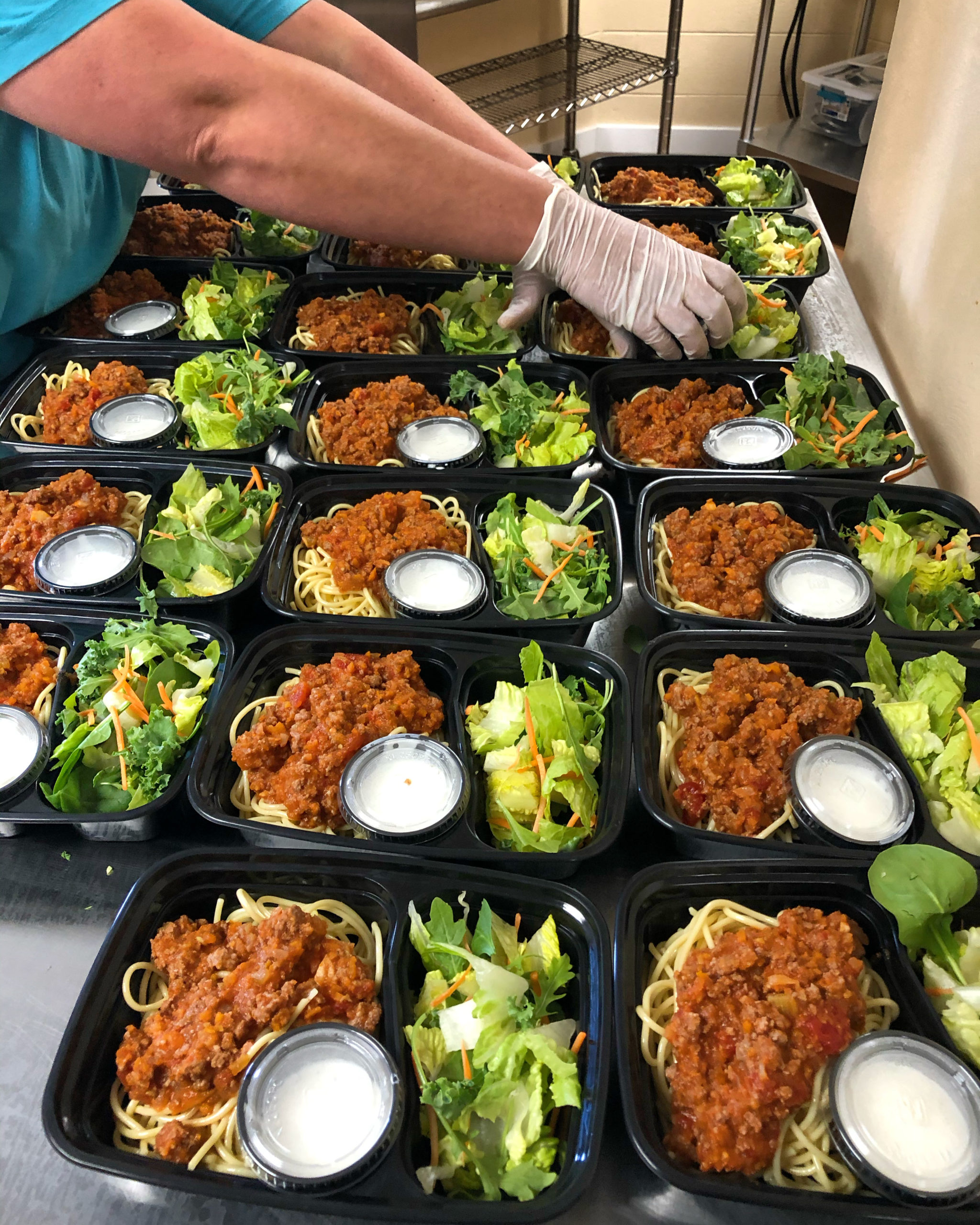 Hands serving trays of food